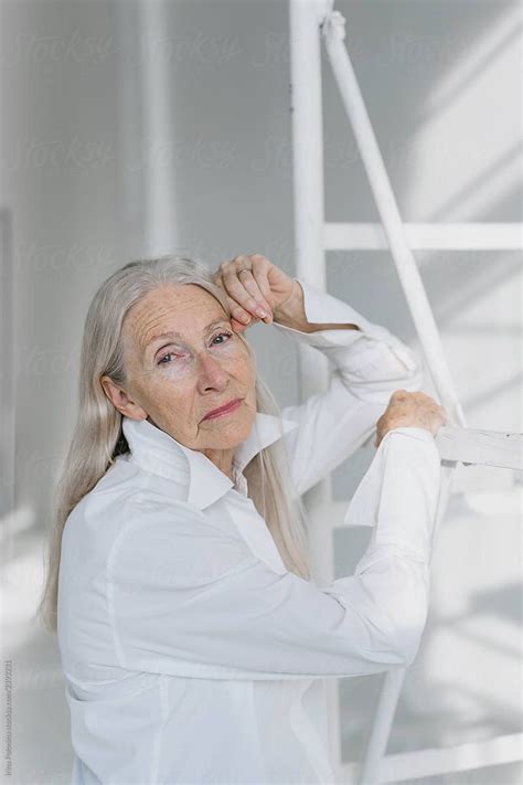 Portrait Of A Senior Woman With Grey Long Hairs Stocksy United Model Release Us Images
