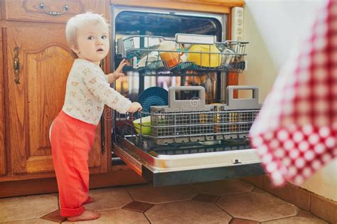 Little Child Helping To Unload Dishwasher Stock Image Image Of Happy