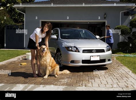 Teenagers washing car in driveway Stock Photo - Alamy
