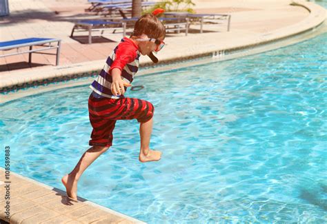 Little Boy Jumping Into Swimming Pool Stock Photo Adobe Stock