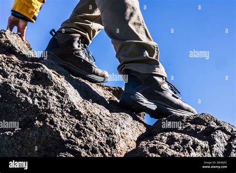 Close Up Of Hiker Legs And Shoes Rocking The Mountain Helping With One