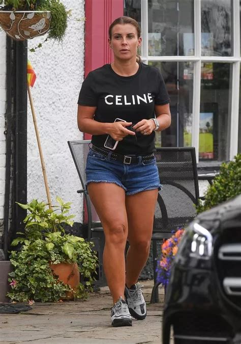 Coleen Rooney Shows Off Incredibly Tanned Legs After Arriving Home From