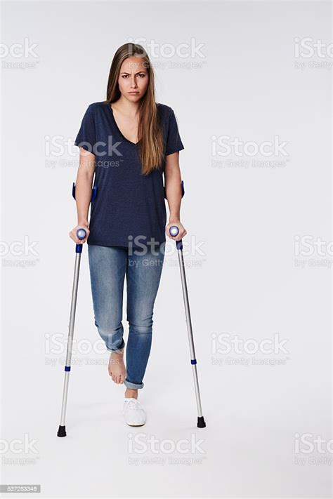 Woman With A Sprain On Crutches Portrait Stock Photo Download Image