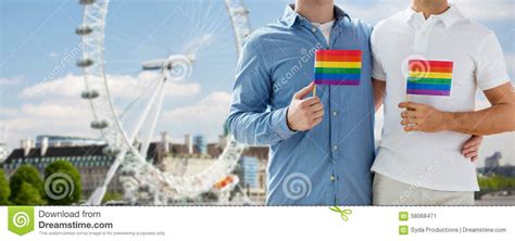 close up of male gay couple with rainbow flags editorial photo image of male partners 58068471