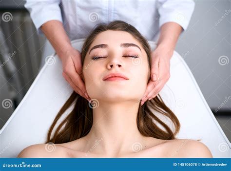 Beautician Cleaning Woman`s Face Spa Skincare Treatment Cosmetologist With Patient On Medical