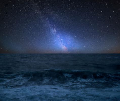 Vibrant Milky Way Composite Image Over Landscape Of Waves Breaki