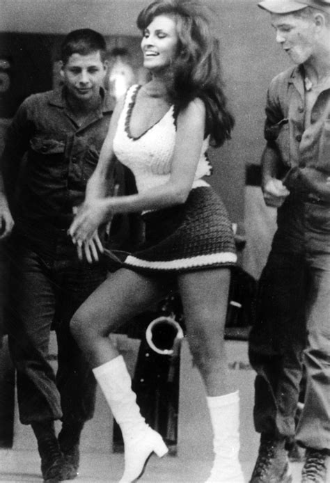 Two GIs Admire Actress Raquel Welch While She Was Visiting The Troops