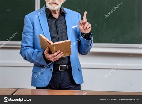 Cropped Image Senior Lecturer Holding Book Showing One Finger Stock