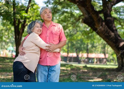 Portrait Of Lovely Elderly Couple Hugging Each Other With Love And Happiness In A Park Outdoor