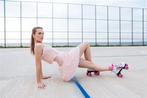 Premium Photo Young Beautiful Woman On Roller Skates Posing On The