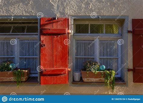 Framework Facade With Red Window Shutters Stock Photo