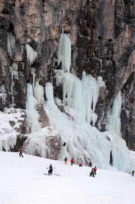 Skiers Observe Ice Climber On Rock Face At Lagazuoi South Tyrol Italy