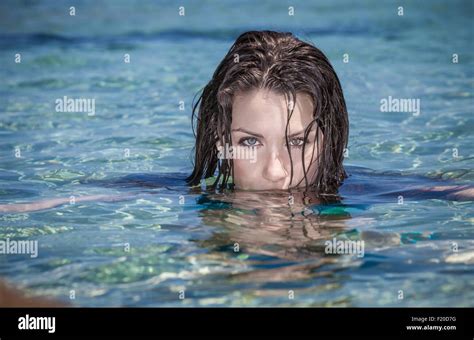 Portrait Of Beautiful Young Woman With Face Submerged In Sea Stock