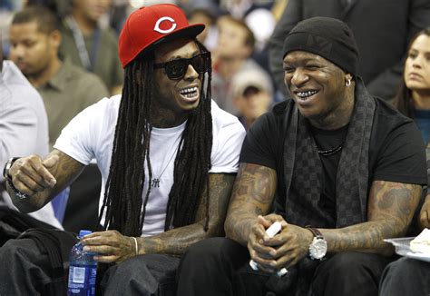 New Orleans Rapper Lil Wayne Sits With Birdman During The New Orleans