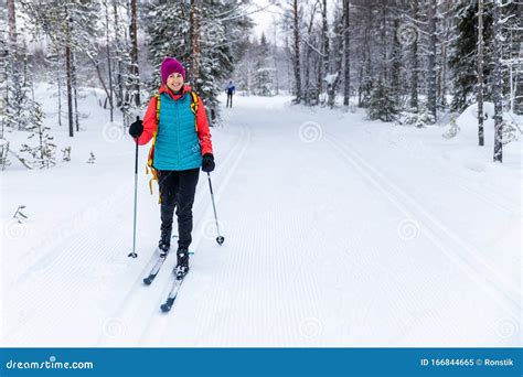 Cross Country Skiing Woman With Skis On Snowy Forest Ski Track