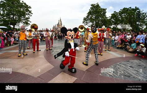 An Entertainer Dressed In A Mickey Mouse Costume Performs During A