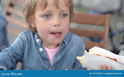 5 Year Old Boy In Denim Shirt Eating Delicious Hot Dog Stock Footage
