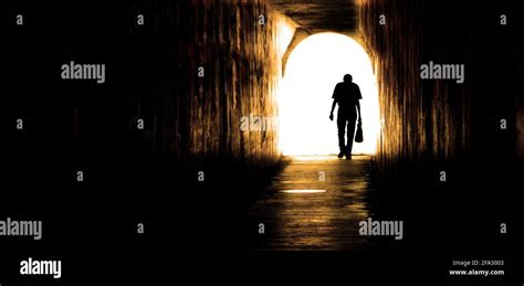 Old Man Walking Through Tunnel Sihouetted Stock Photo Alamy