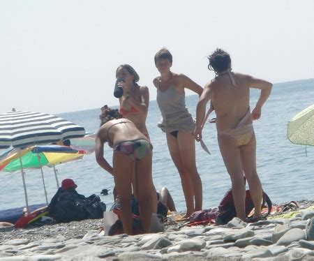 Undressing At Nude Beach