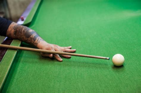 Premium Photo Closeup Of Man Hand With Billiard Cue Ready To Hit
