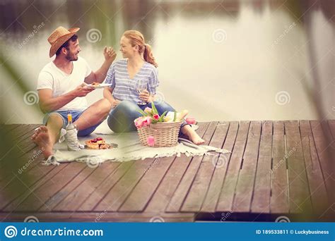 Romantic Picnic On Lakeman And Woman Enjoying At Pie Stock Image