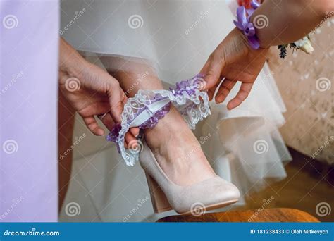 The Bride Puts On Her Leg A Wedding Garter Preparing For The Wedding