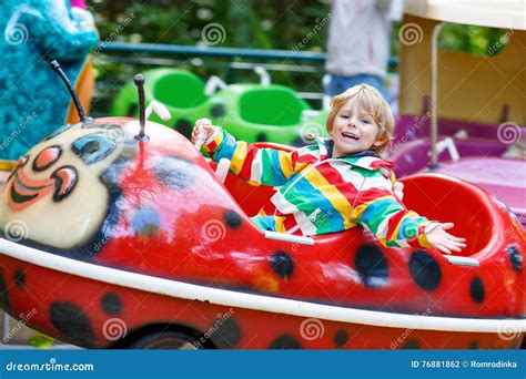 Little Kid Boy On Carousel In Amusement Park Stock Photo Image Of