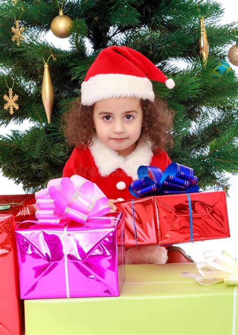 Little Girl Near The Christmas Tree Surrounded By Ts Stock Photo