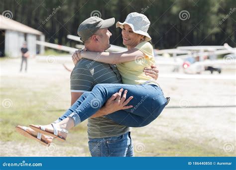 Man Carrying Woman In Arms Stock Photo Image Of Glider 186440850