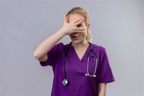 Free Photo Surprised Doctor Young Girl Wearing Purple Medical Gown And Stethoscope Put Her