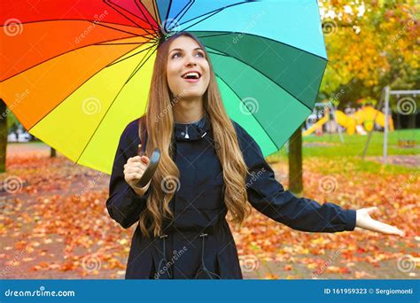 Woman Happy With Umbrella Under The Rain During Autumn Forest Walk