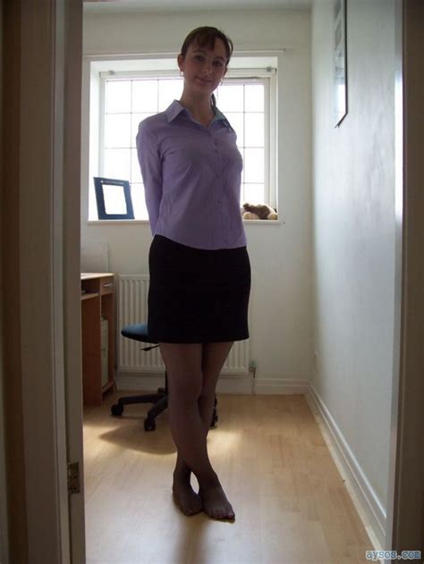 a very cute wife showing off her sexy body in a short skirt and black pantyhose for the camera