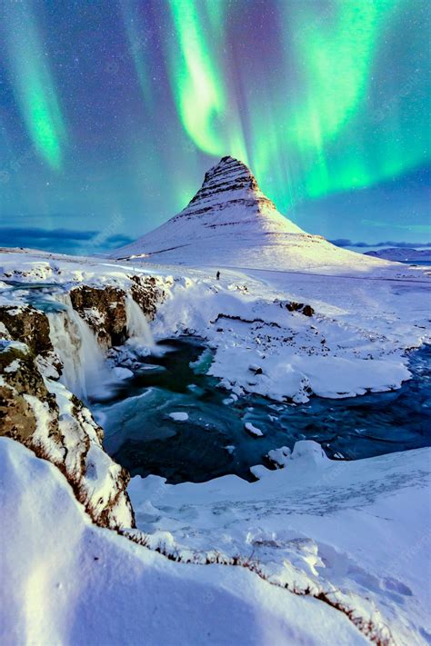 Premium Photo Northern Lights Appear Over Mount Kirkjufell In Iceland