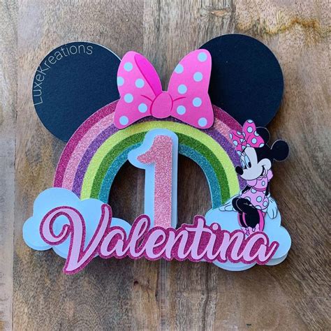 Minnie Mouse Ears With The Number One On It And A Rainbow In The