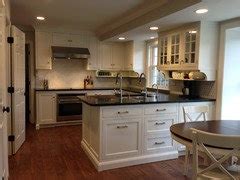 48 inches minimum in a kitchen where more than one cook may be working. Distance between countertop and upper cabinets?