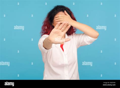 Portrait Of Embarrassed Woman Showing Stop Gesture Covering Eyes With