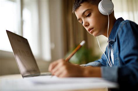 Teenage Boy Listening To Music While Doing Homework Stock ...