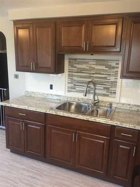 Hampton Bay Cognac Kitchen Cabinets With Subway Tile Backsplash And