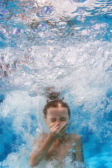 Child Jump Underwater In Pool Sports And Recreation Stock Photos