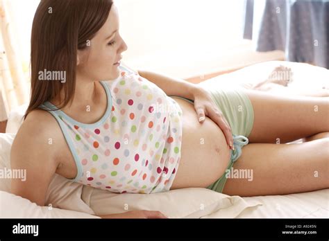 Pregnant Woman Relaxing On Bed Stock Photo Alamy