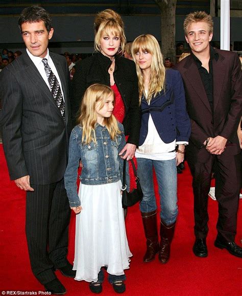 The Family Is Posing For A Photo On The Red Carpet
