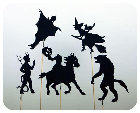 The Silhouettes Of Witches And Cats Are On Sticks