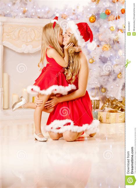 Mom And Daughter Dressed As Santa Celebrate Christmas