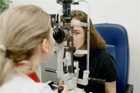 Female Ophthalmologist Examining Vision In Clinic · Free Stock Photo
