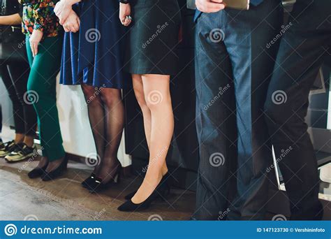 Legs Of Businesspeople. Woman Wearing Skirt, Stockings And High Heels, Man Wearing Dark Trousers ...