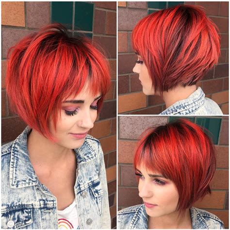 Choppy Red Graduated Bob With Fringe Bangs And Black Shadow Roots The