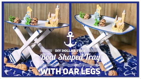 Dollar tree beach themed centerpiece floating sea shells and pearls vase diy / coastal decor ideas. DIY Dollar Tree Boat Shaped Tray / Table With Oar Legs ...