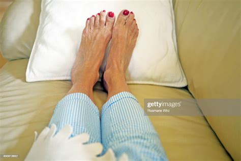 Personal Perspective Of Senior Womans Feet Relaxing On Sofa Photo