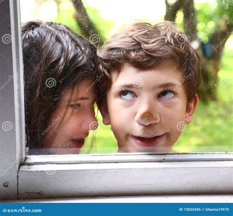 Girl And Boy With Nose Pressed Against Window Stock Photo Image Of