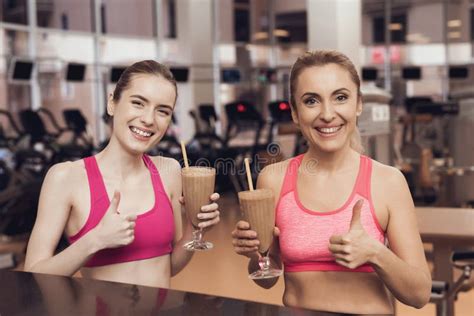 Woman And Girl Drinking Protein Shakes At The Gym They Look Happy